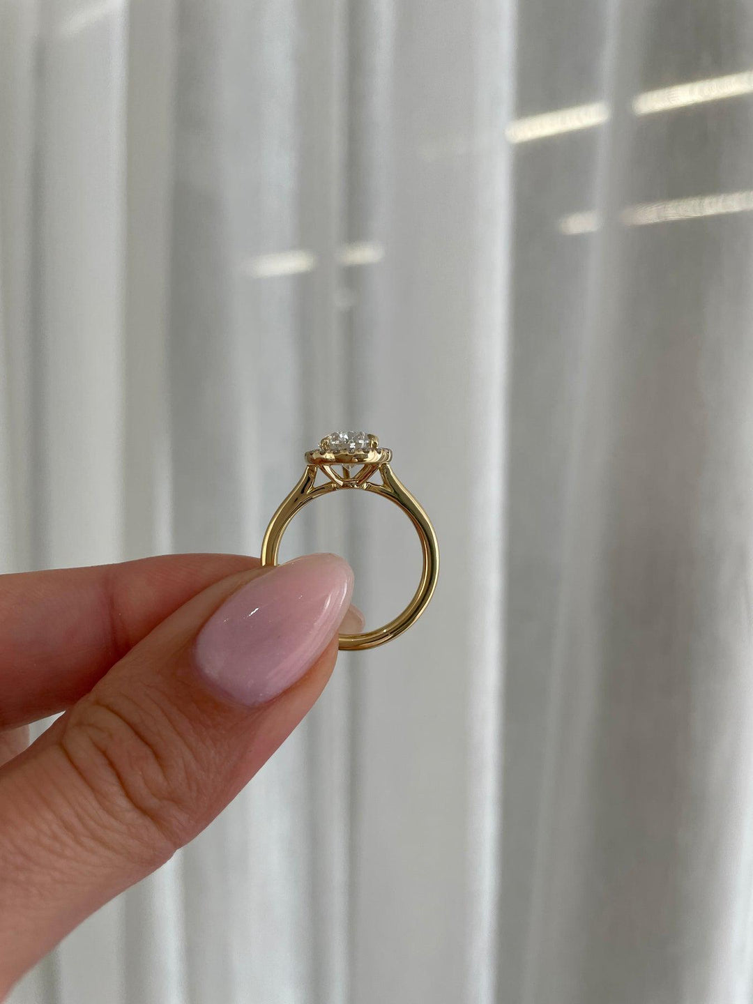 a person holding a ring with a diamond on it