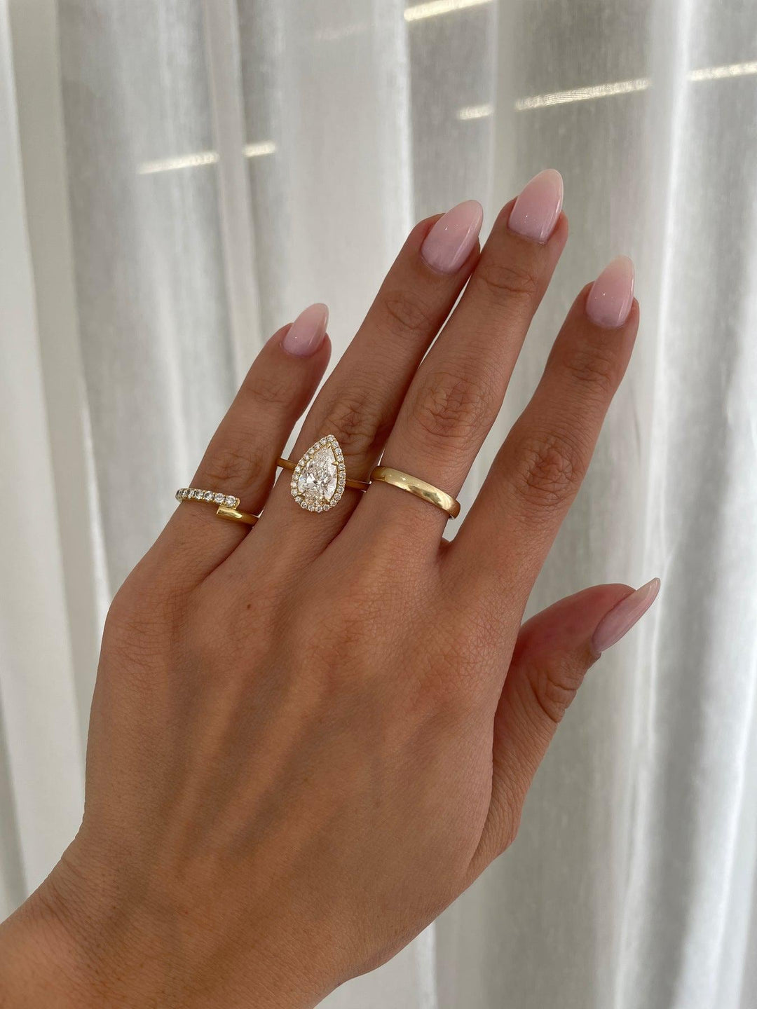 a woman's hand with two rings on it